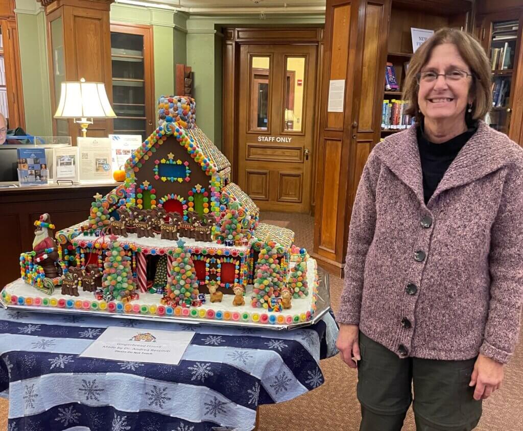 Andrea Resciniti, after she dropped off this year’s gingerbread house. When she drops off the house, she does not return to the library until it’s gone because, she says, it would  make her too nervous to see people get super-close to it. Photo by Ann Sussman