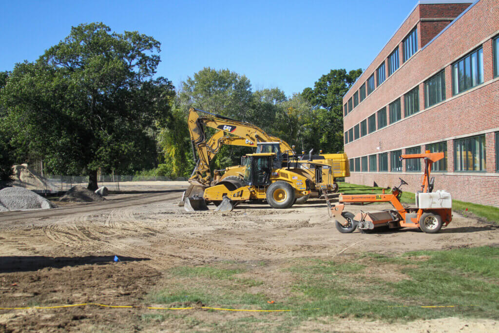 Construction equipment sits on the Novo Riverside Commons construction site beside the existing office building at 300-310 Baker Avenue. Photo: Dakota Antelman/The Acton Bridge