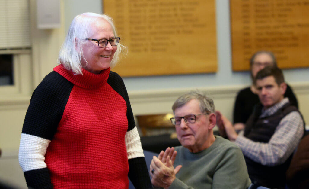 Karlen Reed stands as she accepts a nomination to run for Town Moderator during the 2026 Town Caucus at the Town House on Tuesday, January 27, 2026. Ken McGagh/The Acton Bridge