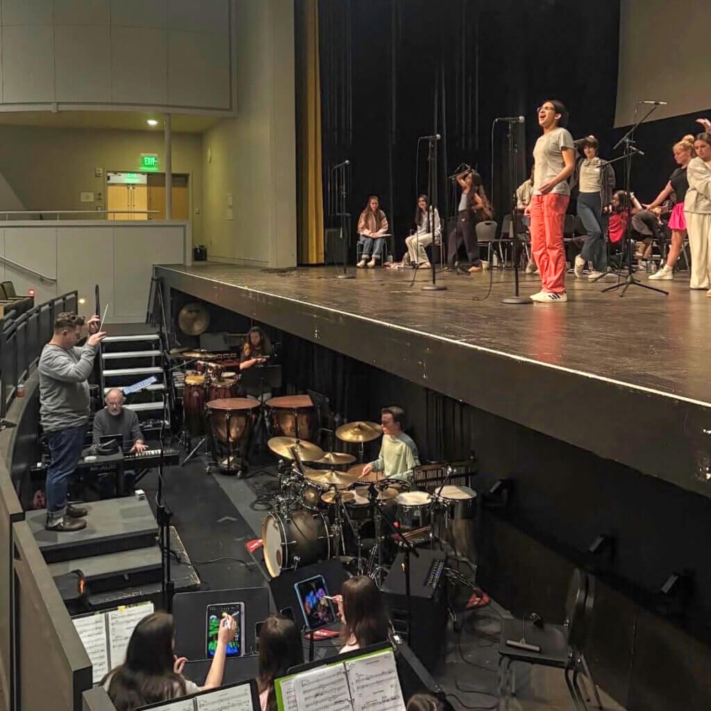 Maya Soto (as Roz) rehearses "Heart to Hart" with the pit orchestra. Photo by Paloma Wigton