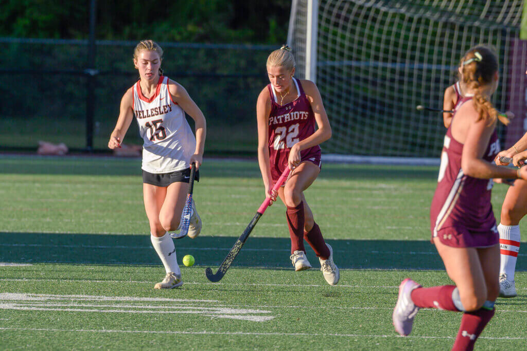 Acton-Carlisle’s Bridget Fivek (No. 22) turns upfield. Fivek’s goal salvaged a tie against perennial powerhouse Wellesley. Photo by David Clancy