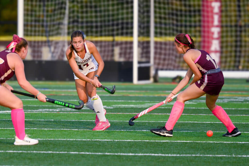 CCHS’ Emerson Ambrose threads the ball between Algonquin defenders on October 2. Photo by David Clancy