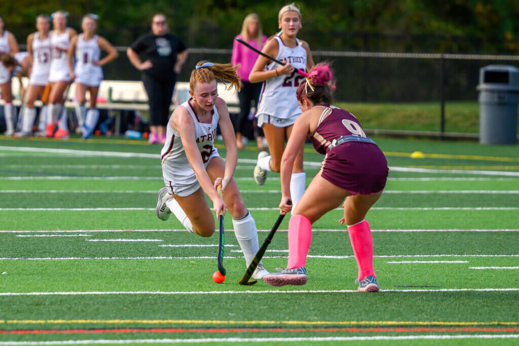 The Patriots’ Julie Reynolds works past an Algonquin defender during their October 2 game. Photo by David Clancy