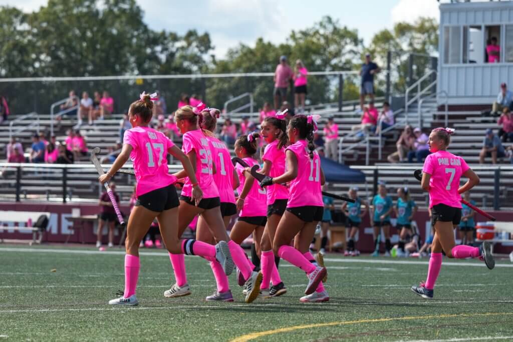 CCHS field hockey players celebrate after freshman Bridget Fivek (No. 22) scored the game-winning goal against North Andover in their Sticks for Cancer game at Acton-Carlisle Regional High School on Saturday, September 27. Acton-Carlisle won 1-0. Photo by Aidan Moroney