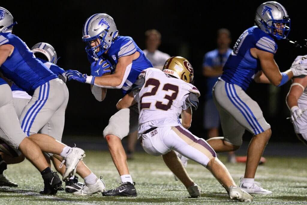 CCHS co-captain Sawyer Carnes (No. 23) tackles Danvers ball carrier Jack Houston on September 10. Photo by Jon Straggas