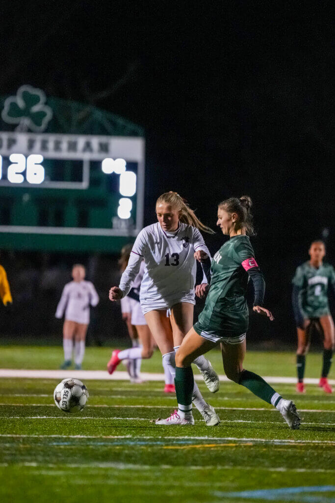 Ainsley Siefer (left) controls the ball through Bishop Feehan's defense. Photo by Aidan Moroney