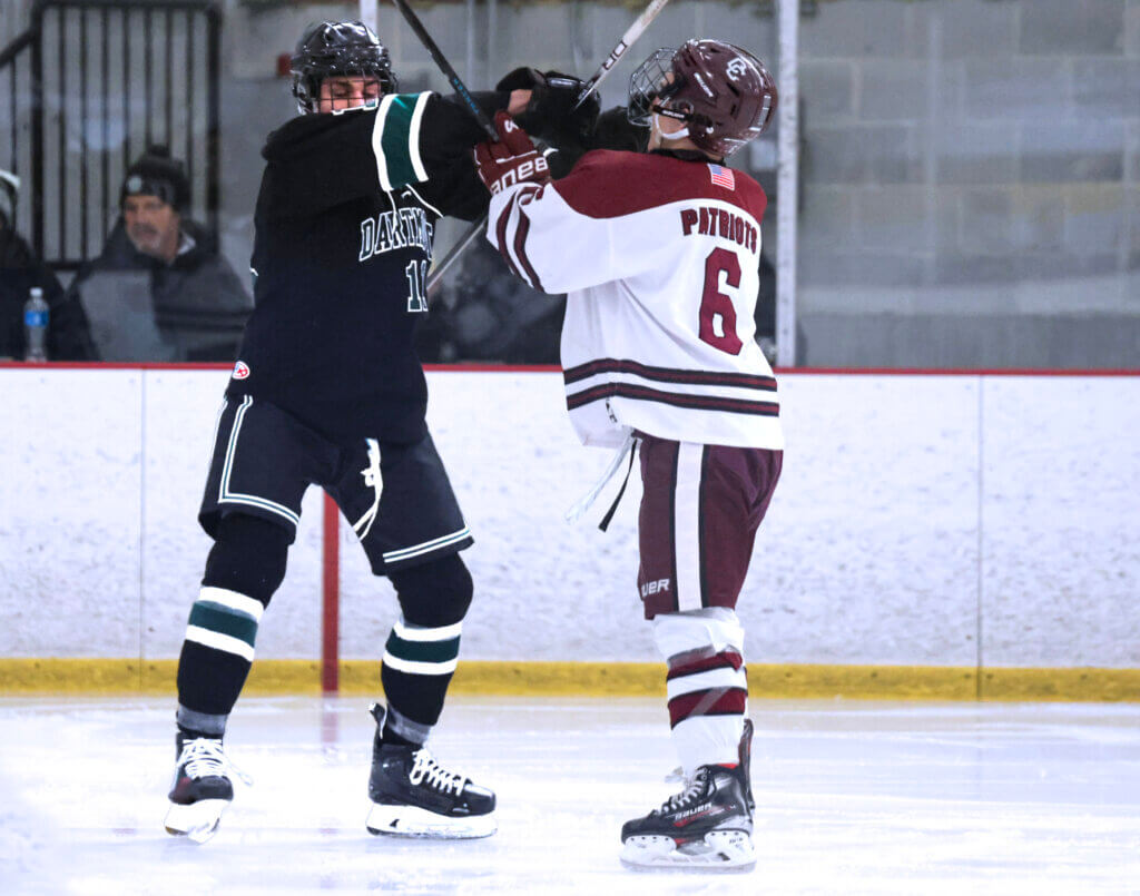 Game heats up, play gets a little gritty with junior Joe Grasso mixing it up with Dartmouth forward. Photo by Leslie Bailey