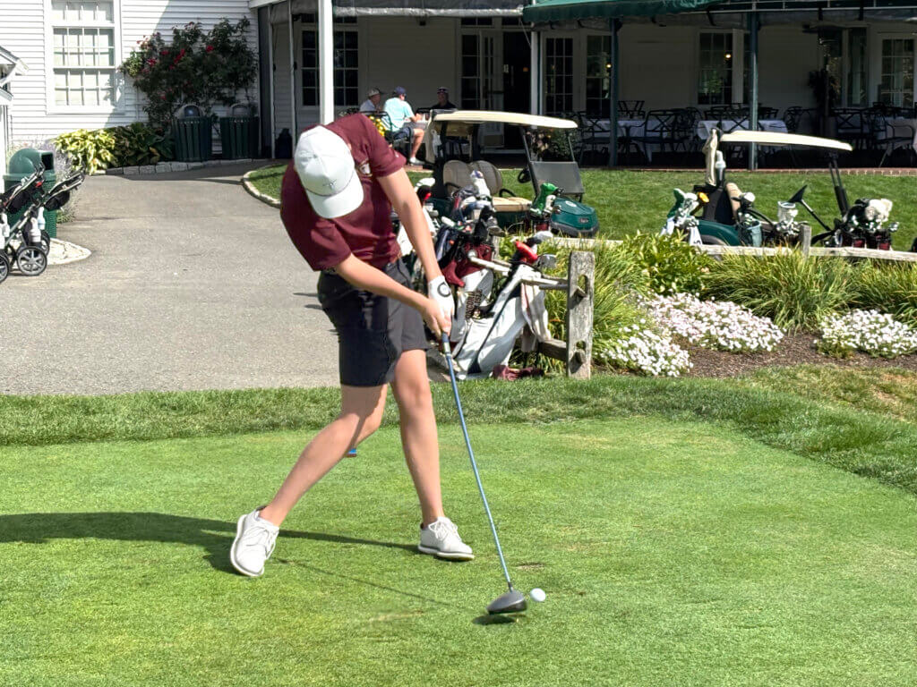 Jake Jones tees off in a match against Billerica. Photo by Carl Sweeney