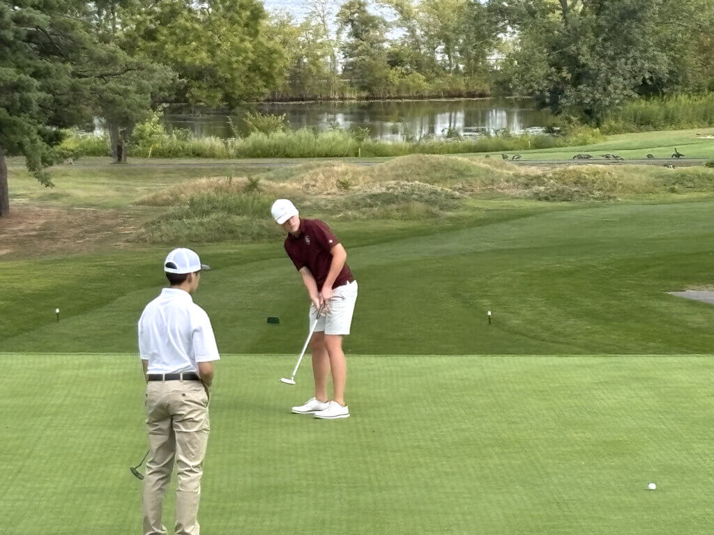 Jake Erston rolls one in on the second hole against Cambridge Rindge & Latin. Photo by Carl Sweeney