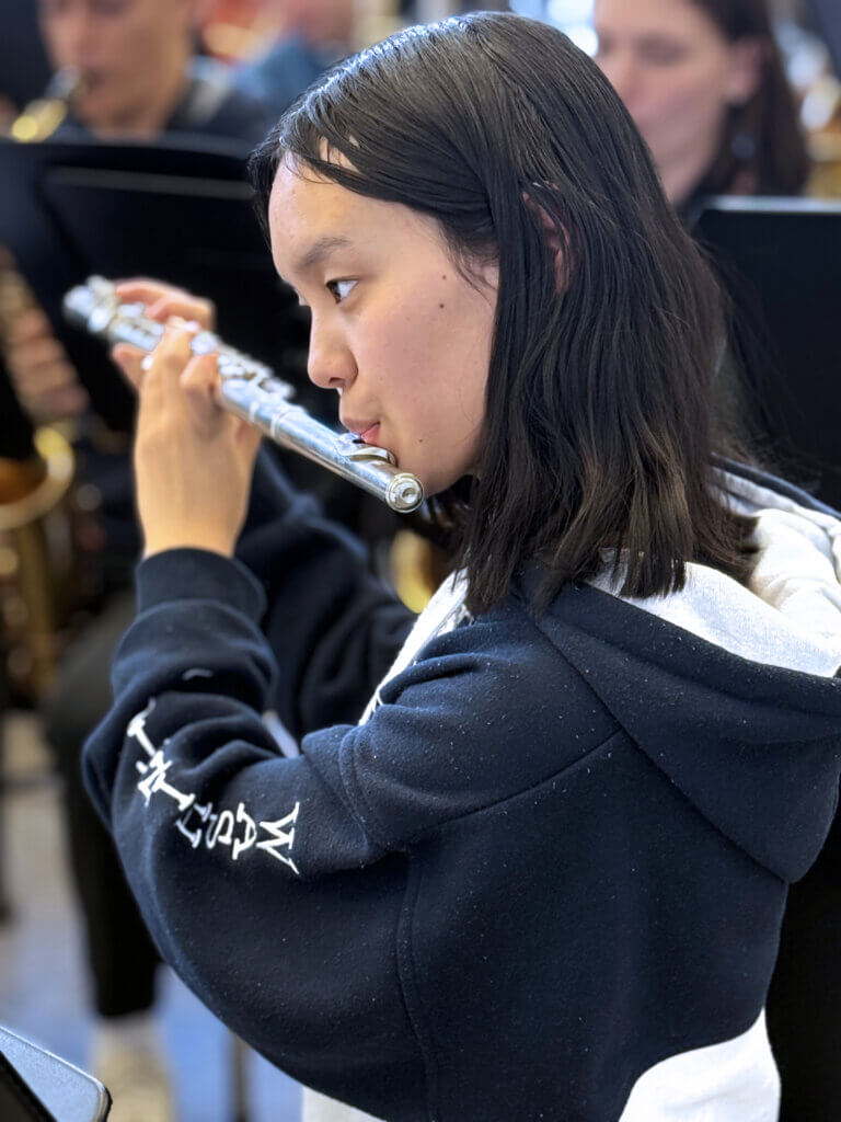 Dongyi Yang of Carlisle on flute, rehearsing with the CCHS Acton Band. Photo: Laurie O’Neill/The Acton Bridge
