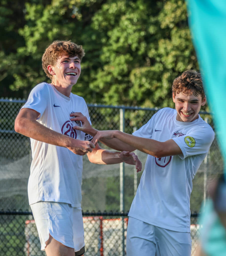 Tyler Shepard (No. 28) and Ben Hackman celebrating after Tyler scored the winning goal against Lincoln-Sudbury on September 11. Photo by Rebecca Woodward