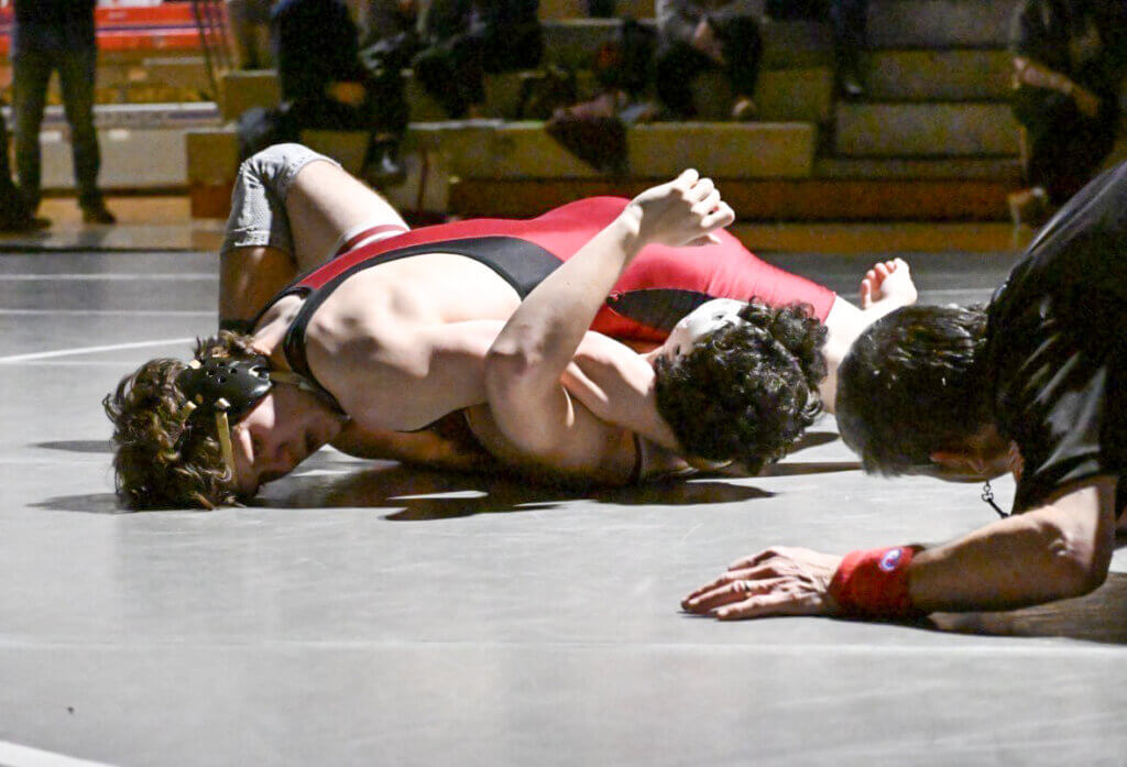 Jonathan Lucas looks for the pin against Westford Academy. Photo by Kim Amouzgar