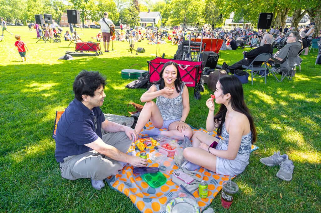 Shingo Yasuhara and daughters Erica and Alyssa enjoy food brought from home. Photo: Stephen Beyer/The Acton Bridge
