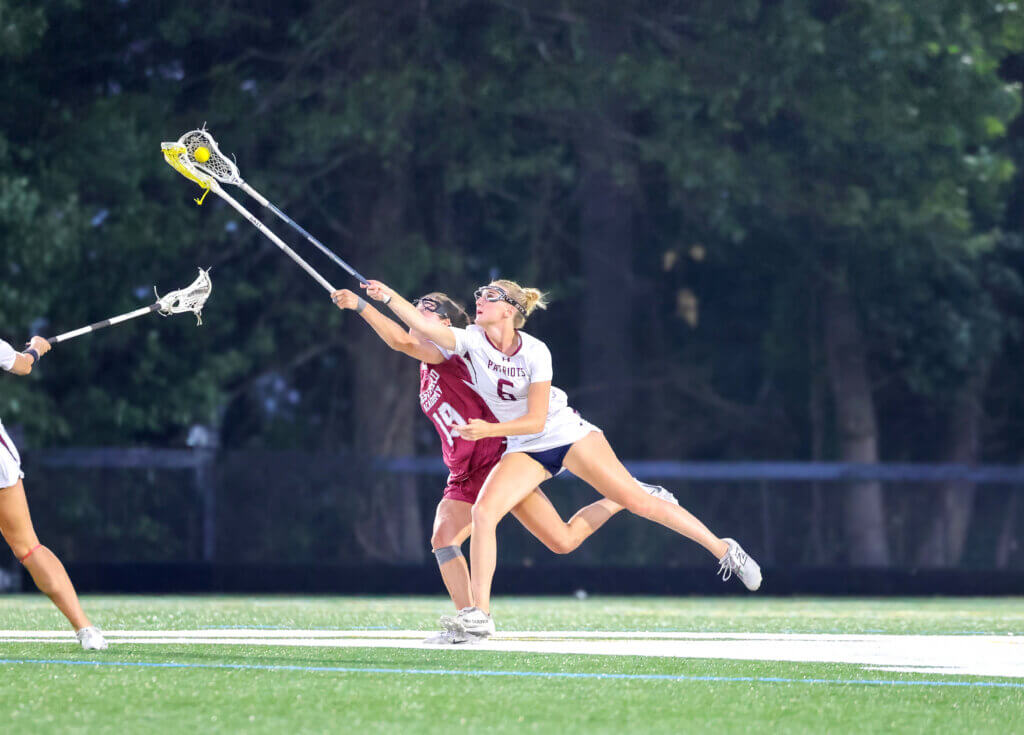 Scarlett Mirak protects the ball from Westford’s Kassidy Carmichael. Photo by Janel Apuna