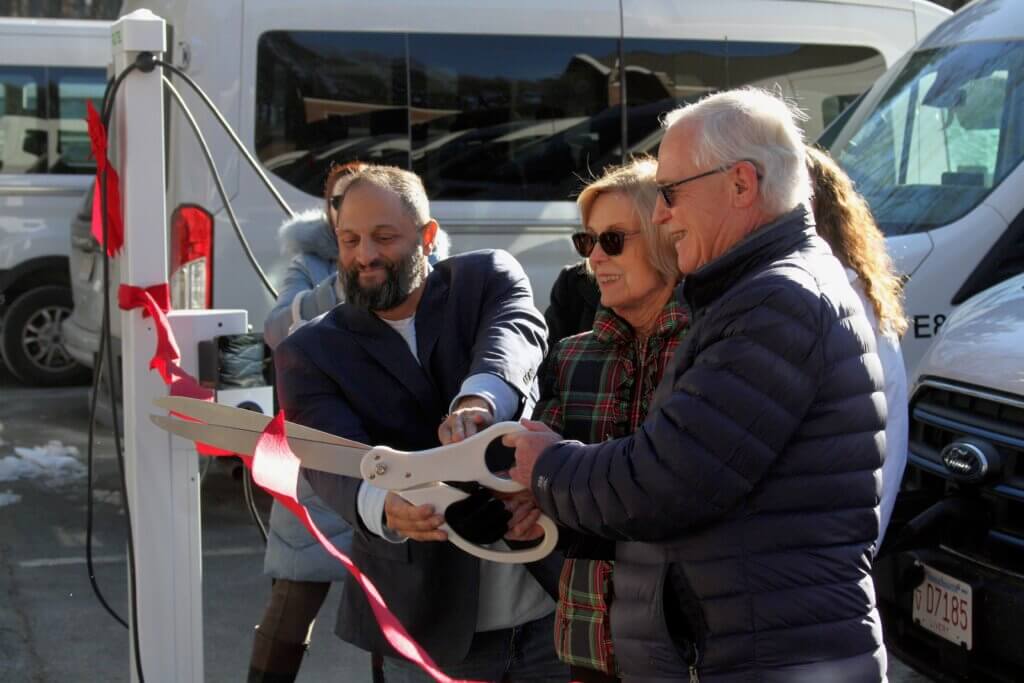 From left, Insight Distributed Energy CEO Brian Kesselman, Minute Man Arc CEO Jean Goldsberry, and state Sen. Michael Barrett cut a ribbon on new electric van chargers. Photo: Dakota Antelman/The Acton Bridge