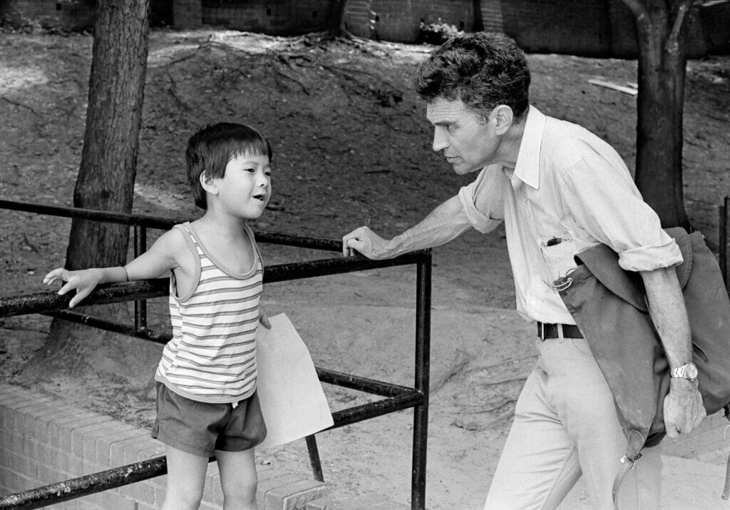 Robert Coles listening to a Cambodian refugee child in Alexandria, Virginia in 1984. Photo by Alex Harris