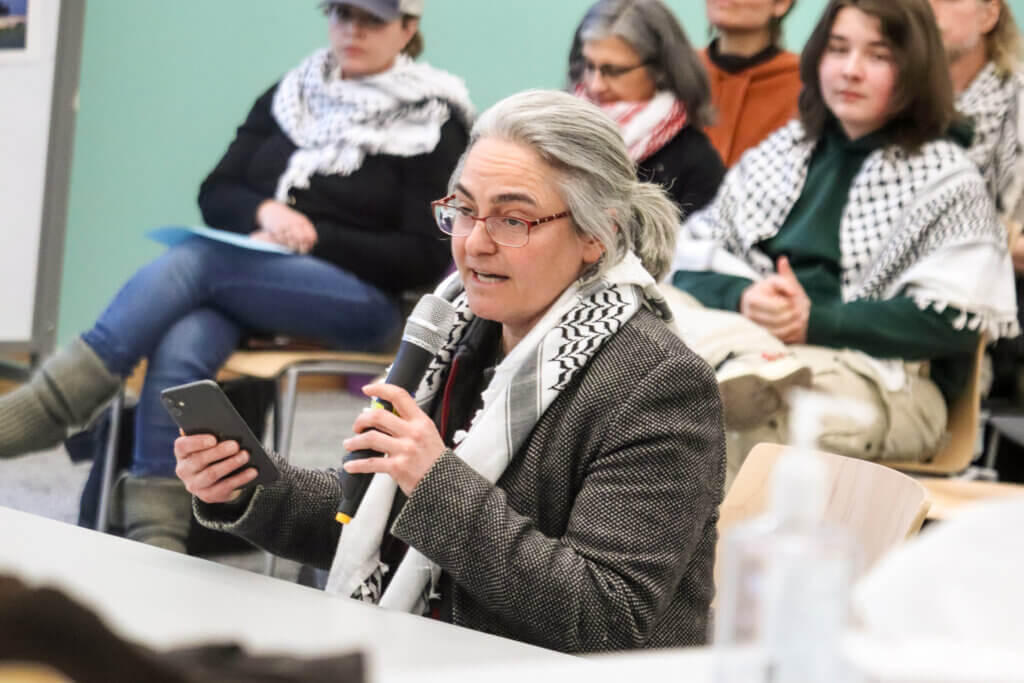 Ece Turnator wore a keffiyeh for the first time at the School Committee meeting. She told committee members, “Yet again, we’re faced with heart-wrenching silence and lack of accountability.” Photo: Trace Salzbrenner/The Acton Bridge