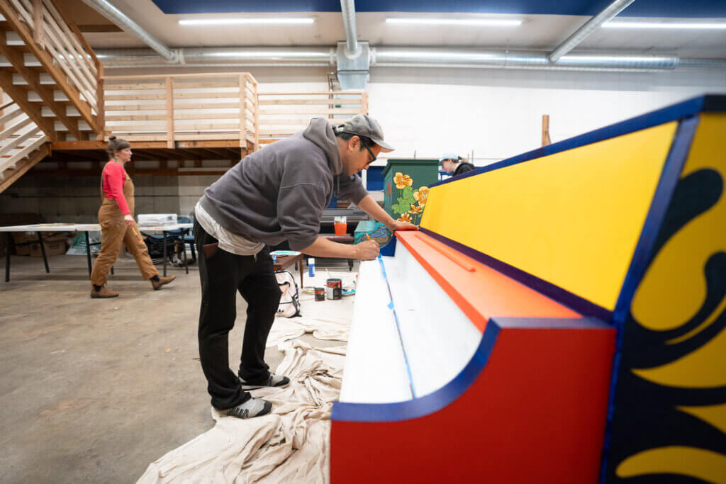 Acton artist Steve Bermundo works on a piano design. Photo by Evan Scales