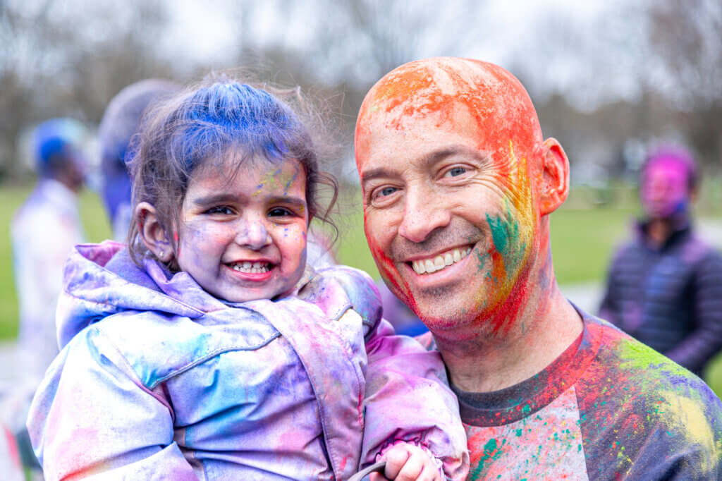 Chris Cratsley and Simi, 2, revel in the afternoon’s colorful powders. Photo: Stephen Beyer/The Acton Bridge