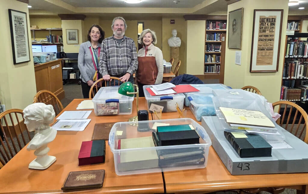 Anke Voss, left, curator of The William Munroe Special Collections, and Sherry Litwack, right, president of the Acton Free Library Corporation, with Kent Bicknell when he delivered the Mather Alcott Collection to the library. Courtesy photo