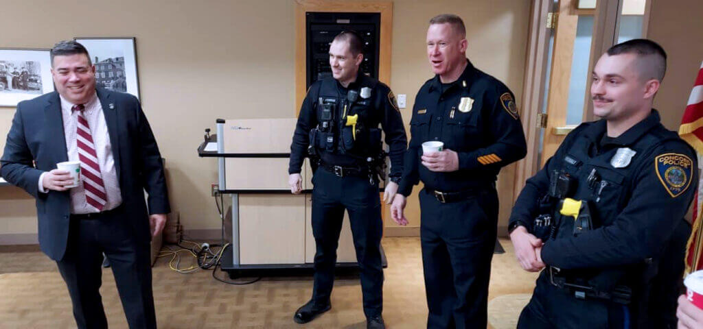 Chief Joseph O'Connor, left, shares a light moment with Department members. (Photo Courte- sy Acton Police Department)