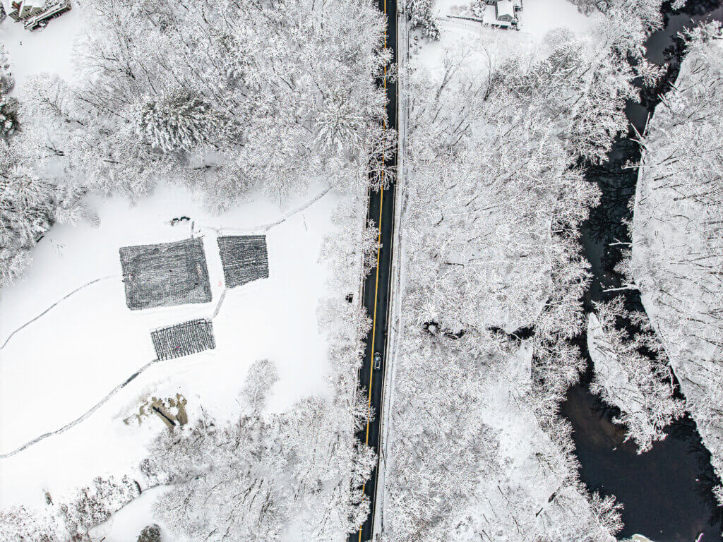 If their subsequent flight took them above Macones Pond, they’d have glimpsed this aerial view, with cleared skating areas on the left, the Assabet River on the right, and Lowell Road running up the middle. Photo: Stephen Beyer/The Acton Bridge