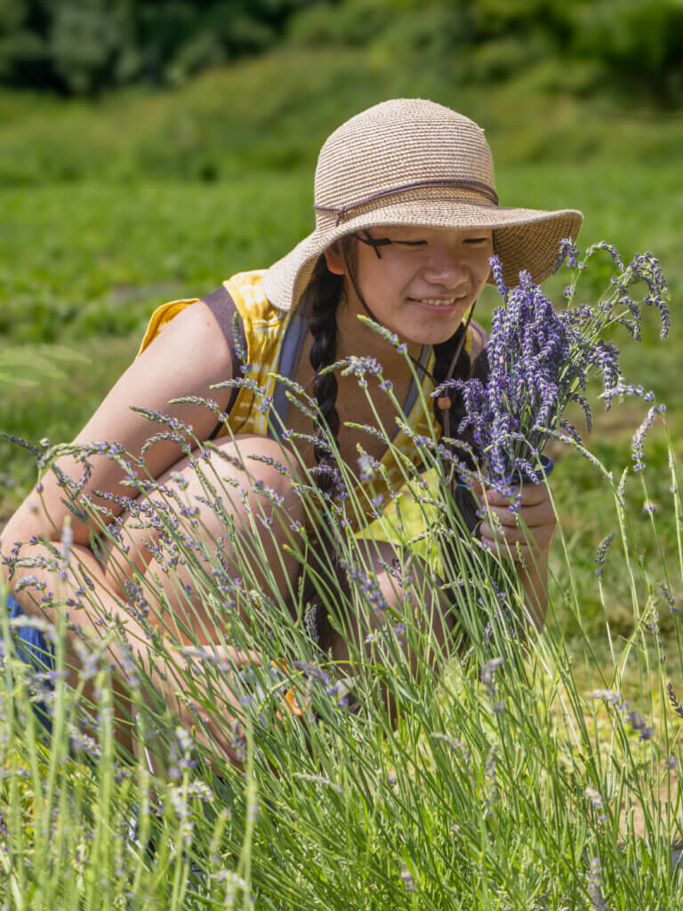 Allison Lu, 18, of Acton inhales the scent. Photo by Jean Fain