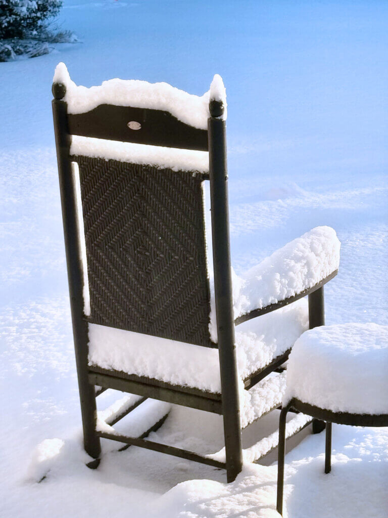 Monday morning’s light spills over a snow-laden table and chair. Photo courtesy of Lizzie Lewis