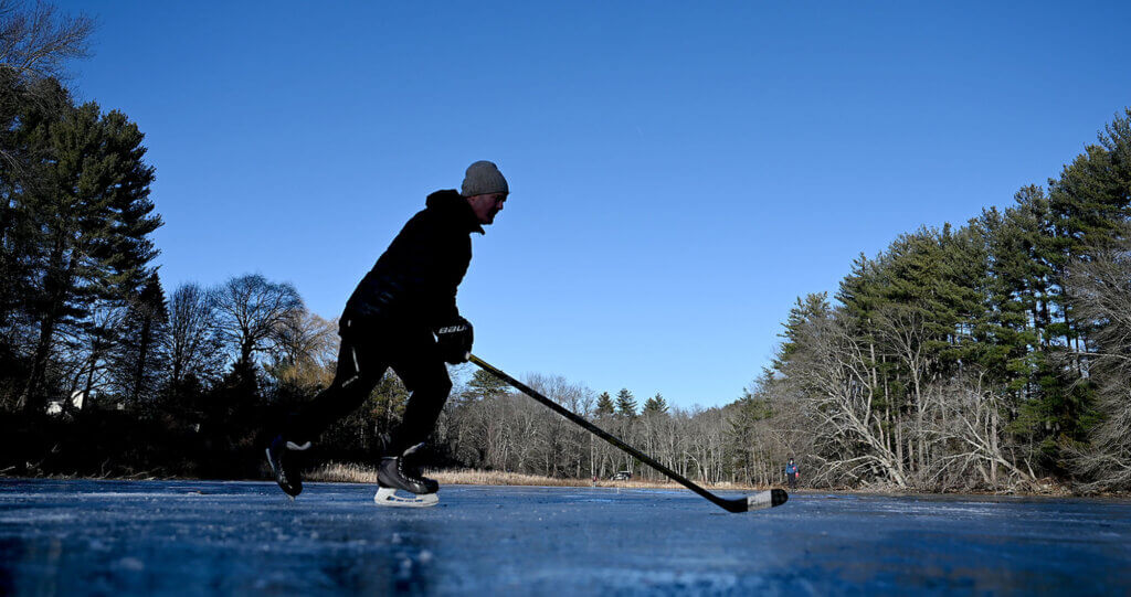 Jack Kelleher of Acton skates underneath a beautiful blue sky at Nick Macone Pond on Friday January 10, 2025. While Walden Pond gets all the attention and fame, Concordians who like to skate are drawn to the small and shallow body of water off Lowell Road. Acton skating enthusiast, Jason Andrews, whose in-laws live next to the pond, serves as the pond’s de facto caretaker. Andews measures and updates locals on the thickness, clearsthe ice of snow and records the number of days the ice is good for skating. Ken McGagh/The Acton Bridge