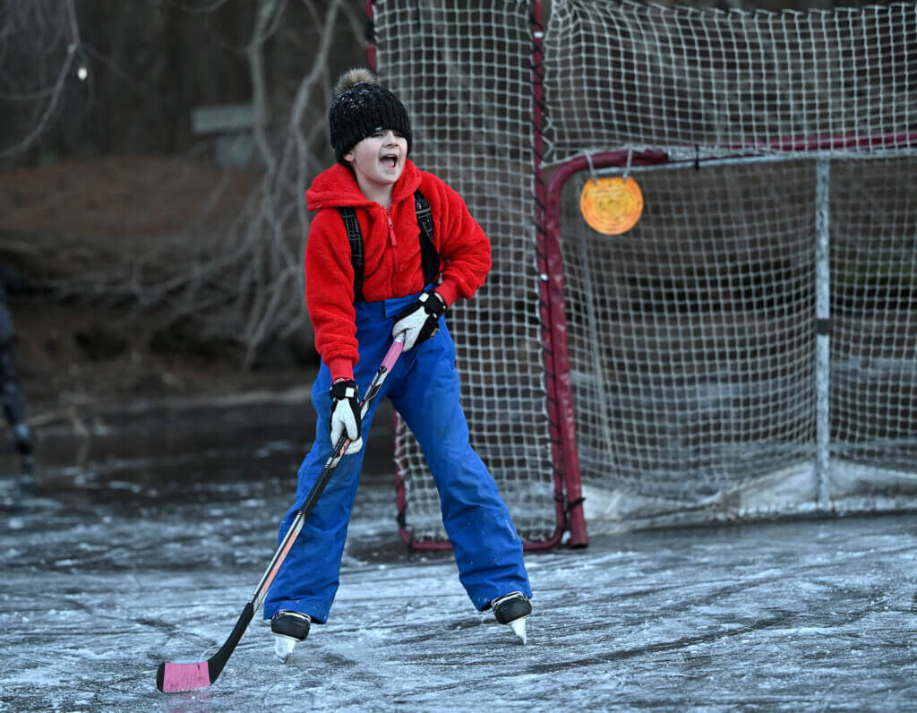 Caroline Hanson, 10, of Acton, wants a pass from her father Sam Hanson, at Nick Macone Pond on Lowell Road, Friday January 10, 2025. Ken McGagh/The Acton Bridge