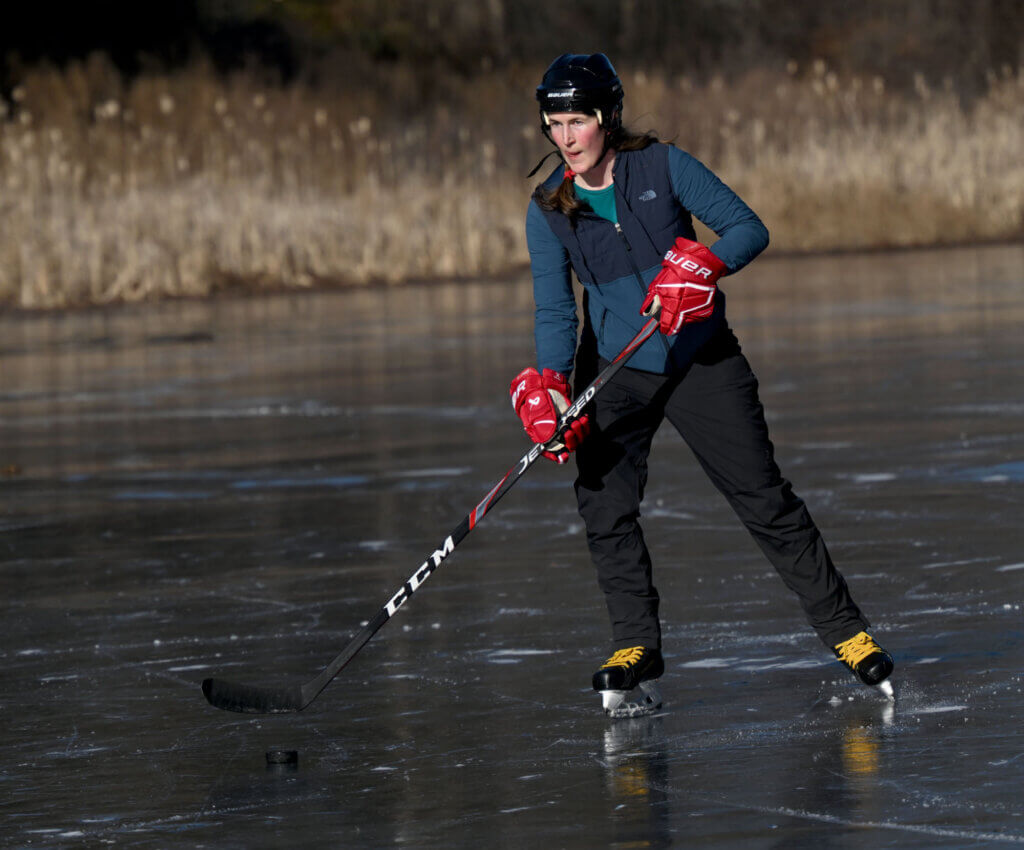 Anna Sjogren of Acton passes around a hockey puck at Nick Macone Pond on Lowell Road, Friday January 10, 2025. After her children took up ice skating, Sjogren took adult lessons and learned to skate herself. Ken McGagh/The Acton Bridge