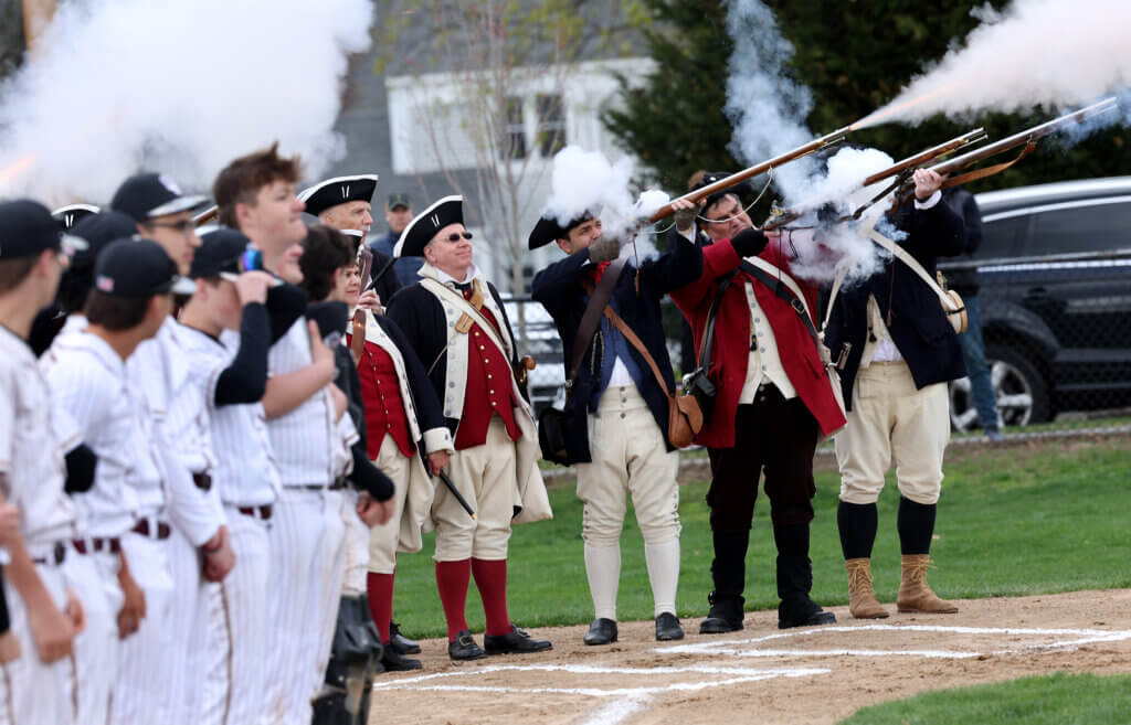 The Acton MInute Men fire a musket salute to kick off the game. Photo: Ken McGagh/The Acton Bridge