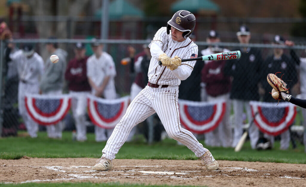 Acton-Carlisle’s Joe Grasso tracks a Lexington pitch. The Patriots routed the Minutemen 15-1. Photo: Ken McGagh/The Acton Bridge
