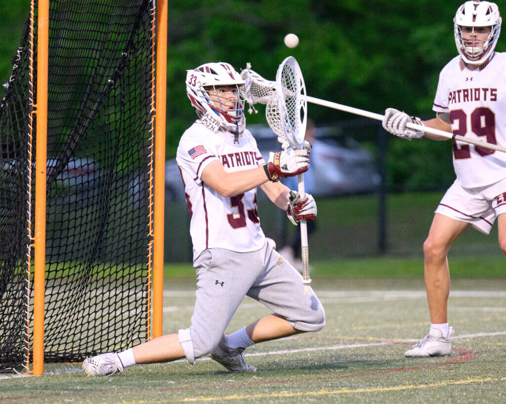Acton-Carlisle goalie Ben Wonsek (No. 33) saves a shot by Boston Latin. Photo by Jon Straggas