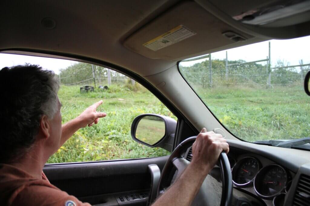 Hutchins Farm manager Brian Cramer points to one of many fences installed around the property. Photo: Dakota Antelman/The Acton Bridge