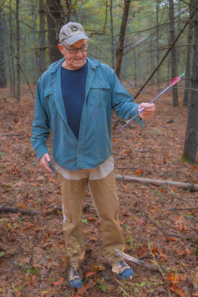 Hunter Frank Patterson discovers a lost arrow during a deer scouting trip in the Wright Woods area. Photo by Jean Fain