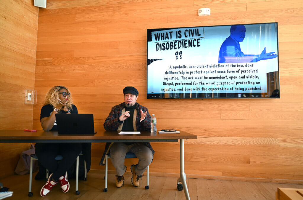 Acton historian Richard Smith, right, speaks as Nikki Turpin, president of The Robbins House looks on, during an interpretive program on civil disobedience in commemoration of Martin Luther King Day at the Walden Pond Visitor Center on Monday, January 20, 2025. Ken McGagh/The Acton Bridge