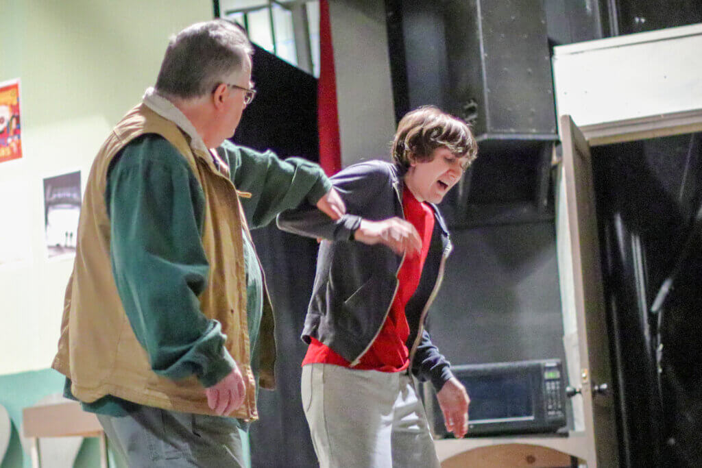 John Small, left, and Finian Ross rehearse a scene in which Small portrays a train security officer encountering the main character, Christopher. Photo: Trace Salzbrenner/The Acton Bridge