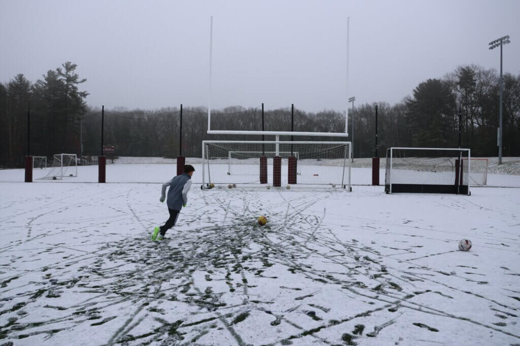 Brandon Velez trains on a snowy field at Acton-Carlisle High School in January 2024. Photo by Janel Apuna