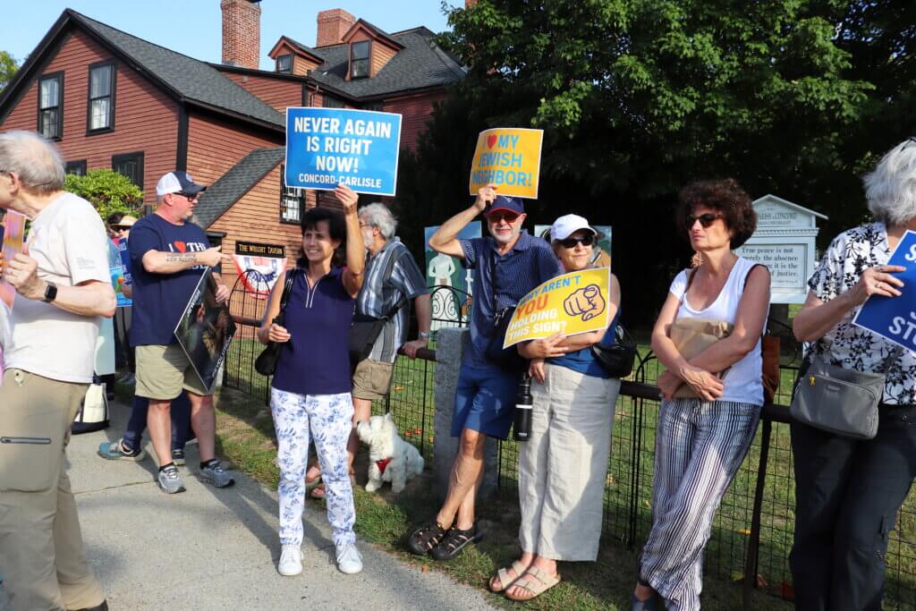 Rallygoers assemble next to Wright’s Tavern. Photo: Trace Salzbrenner/The Acton Bridge
