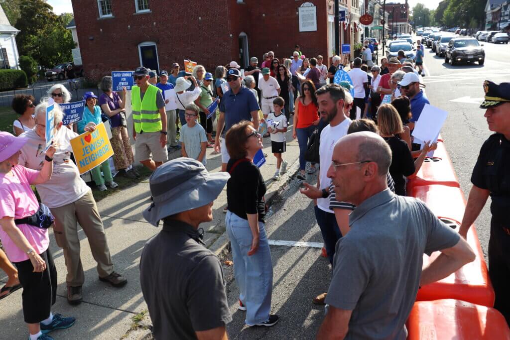 Rallygoers fill the sidewalk as they prepare for the event. Photo: Trace Salzbrenner/The Acton Bridge