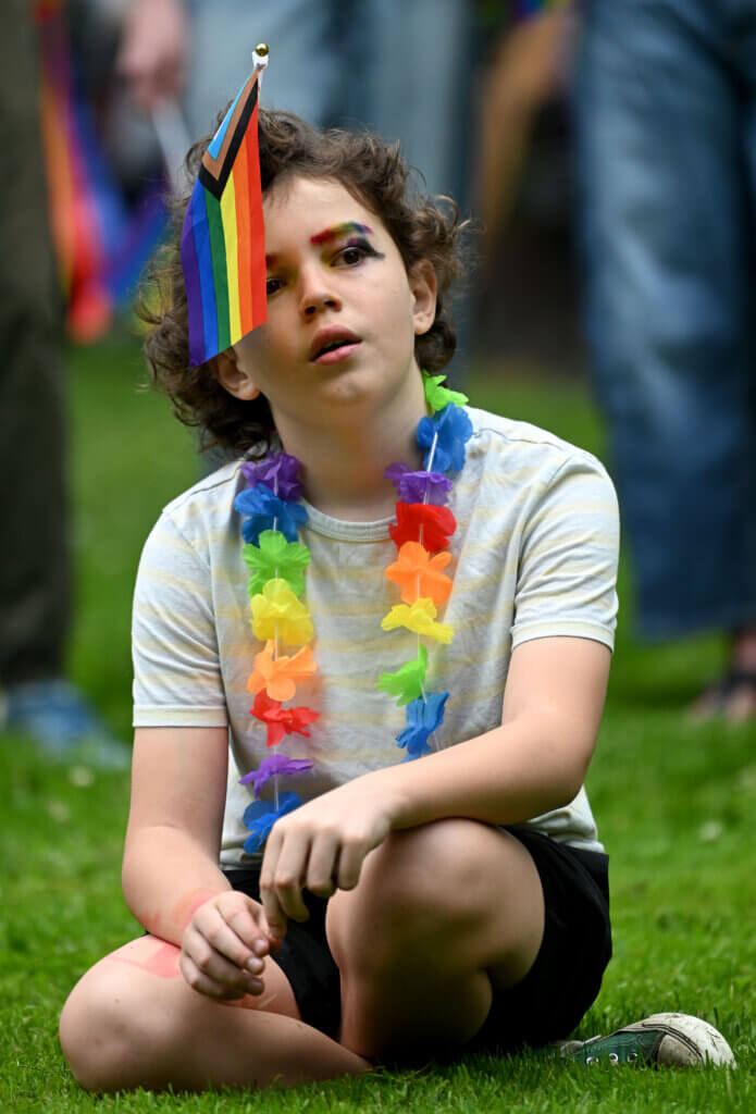 Concordian Luke Hawker, 11, of Acton, adorned with the Progress Pride flag and a rainbow lei.
