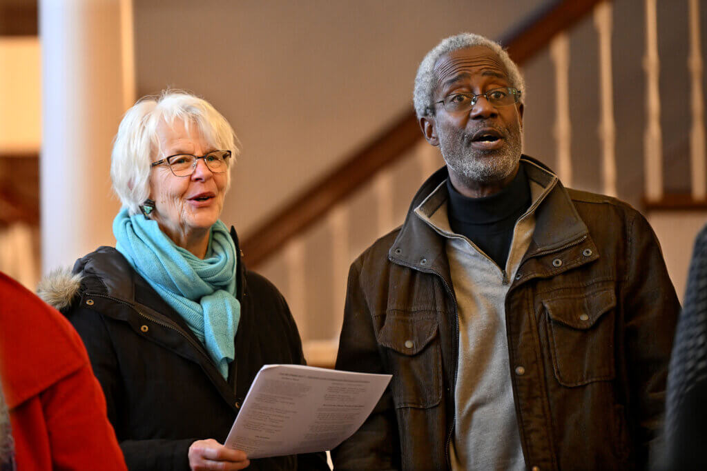 Michael Williams and his wife Clary Bestor-Williams of Acton sing “This Little Light of Mine” during the Acton-based Music Makes Me Happy Chorus’ Martin Luther King Day concert “Let My People Go” at Trinitarian Congregational Church on Monday, January 20, 2025.  The concert was the last of four  MLK Day events that  Michael Williams participated in or attended Monday.  Ken McGagh/The Acton Bridge