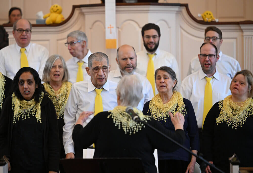 The Acton-based Music Makes Me Happy Chorus, a chorus for adults with special needs, performs  MLK Day concert “Let My People Go” at Trinitarian Congregational Church on Monday, January 20, 2025.  The chorus sang a series of spirituals and gospel songs including  “Go Down Moses,” “We Shall Overcome,” “Swing Low, Sweet Chariot,”  “Michael, Row the Boat Ashore,” “Wade in the Water,” “This Little Light of Mine,” and “When the Saints Go Marching In.” Acton historian and Henry David Thoreau interpreter  Richard Smith also gave a presentation  during the concert.   Ken McGagh/The Acton Bridge