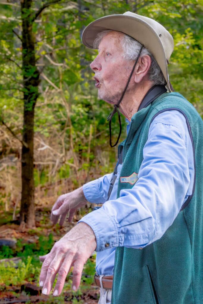 Peter Alden demonstrates bird behavior as he educates. Photo: Jean Fain/The Acton Bridge