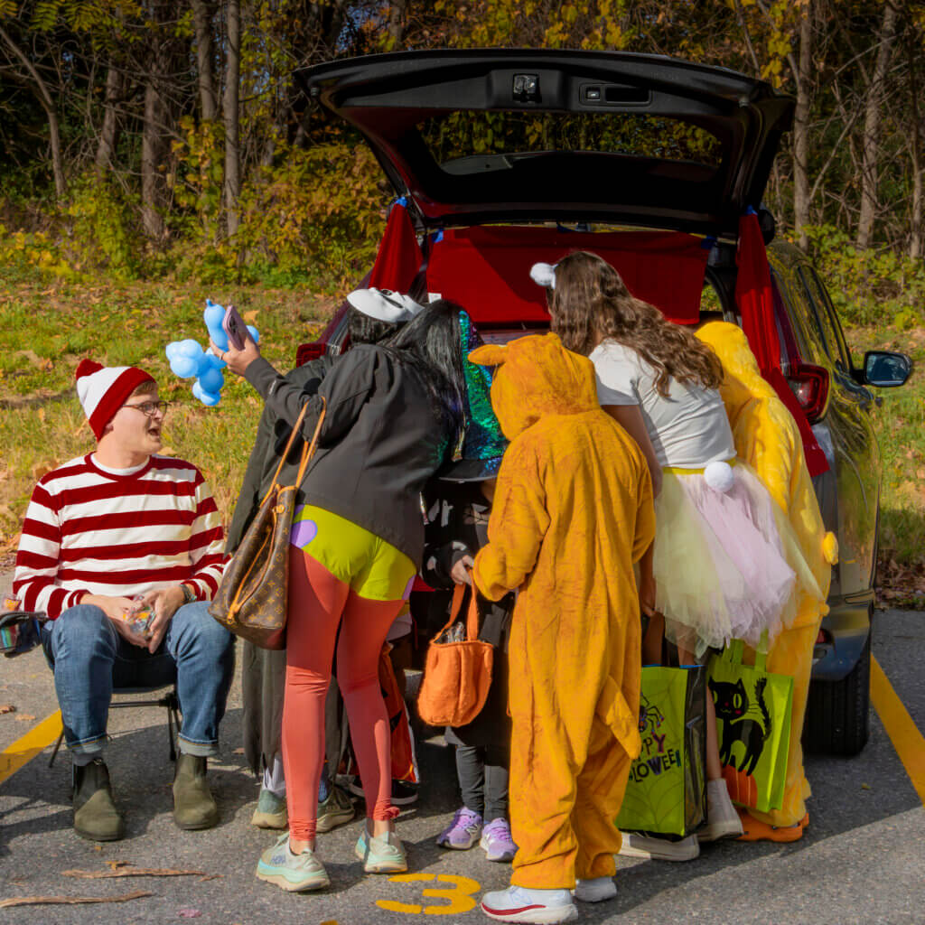 Trunk-or-Treaters descend on a car for their Halloween goodies. Photo: Jean Fain/The Acton Bridge