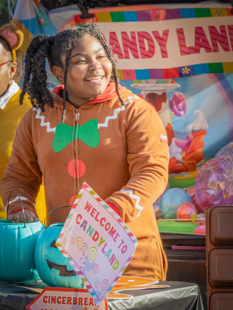 Nine-year-old Gingerbread Girl Kamya Williams shares sweets and good cheer at the Candyland table. Photo: Jean Fain/The Acton Bridge