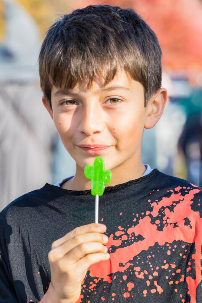 Max Hickson, 11, takes a break from trick-or-treating to enjoy an apple-flavored lollipop. Photo: Jean Fain/The Acton Bridge