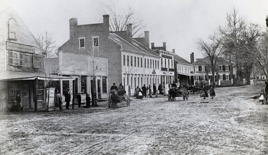 Downtown Acton, Massachusetts - Acton Center South Side toward West, 1860...1865. 
The Parkman House, where the Thoreau family lived for a time, is the right-most visible house in the background. See Additional Info for more on the house / the timing of them living there.
CREEPY PAIR OF CHILDREN in the middle of the street :D (EM loves)
street scenes, town square, town center, shops commerce stores
people men women crowd gathering, daily life, wagons roads carts
bare trees - winter or fall autumn
