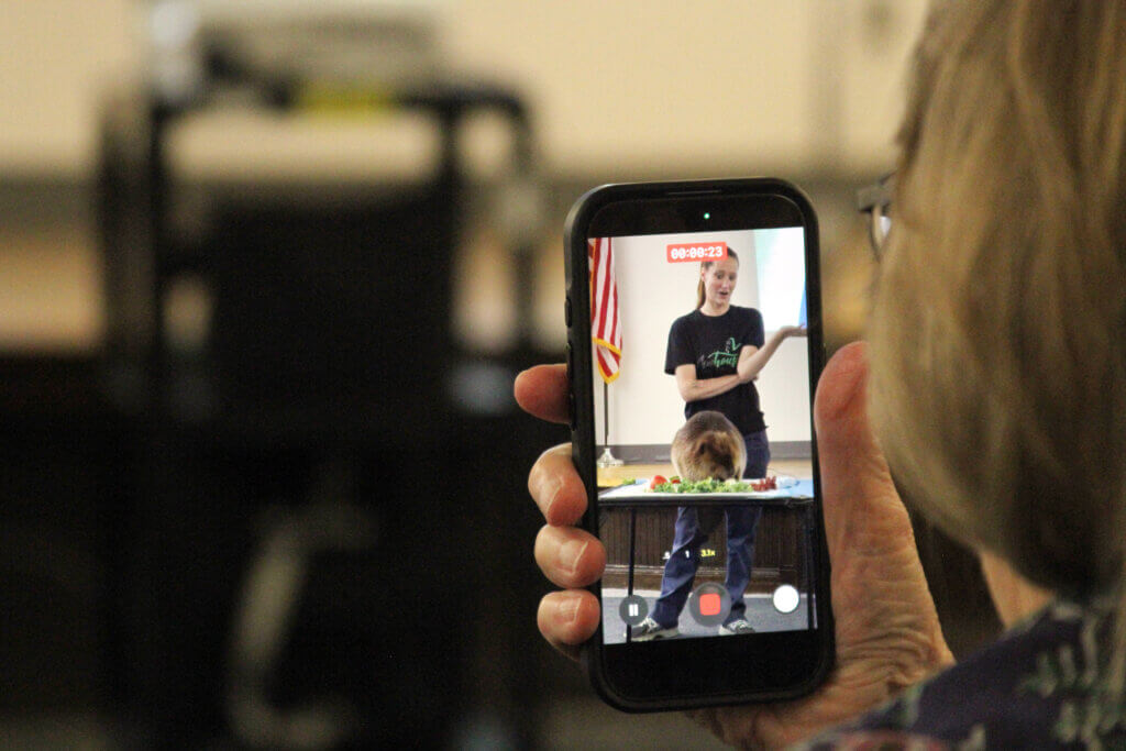 Acton resident Bonnie Geithner gets Nibi on video. Photo: Dakota Antelman/The Acton Bridge